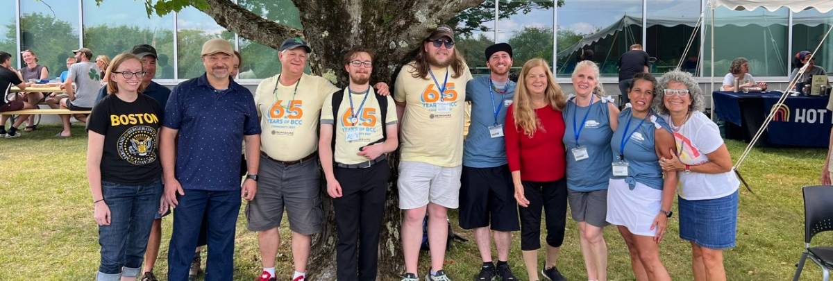 BCC alumni standing under a tree on campus